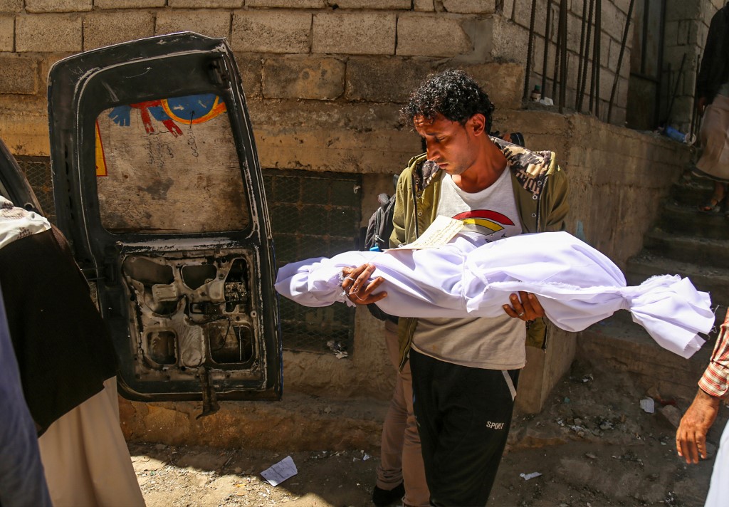 A Yemeni man carries the body of a child killed in a mortar shell attack on the country's flashpoint southern city of Taiz. (File/AFP) A Yemeni man carries the body of a child killed in a mortar shell attack on the country's flashpoint southern city of Taiz. (File/AFP)