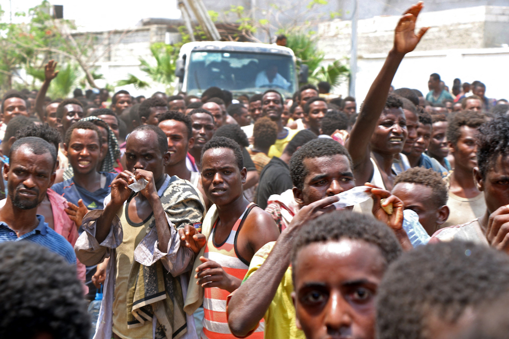 African migrants receive food and water inside a football stadium in the Red Sea port city of Aden in Yemen, on April 23, 2019. (AFP/File Photo) African migrants receive food and water inside a football stadium in the Red Sea port city of Aden in Yemen, on April 23, 2019. (AFP/File Photo)