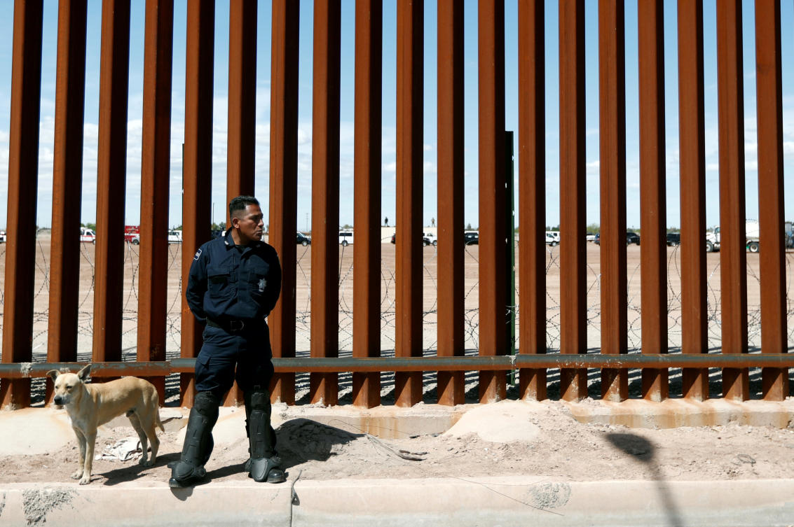A Mexican federal police member stands guard during the visit of then-US President Donald Trump to Calexico, California, as seen in Mexicali, Mexico April 5, 2019. (Reuters)